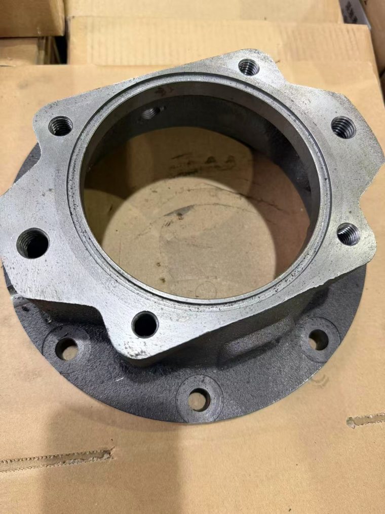 Machined cast iron bearing housing flange with mounting holes